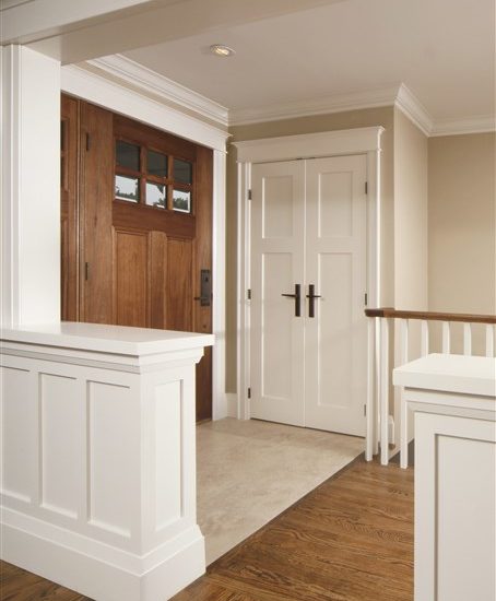 craftsman shaker hallway with front door and trim