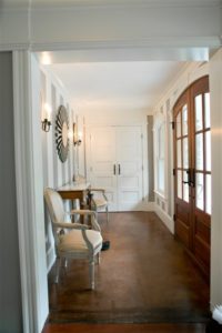 hallway with white shaker doors and stained french doors
